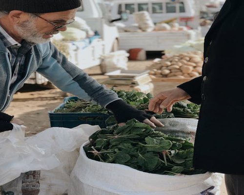 Fresh dark green spinach and morning harvest vegetables from a local market stall